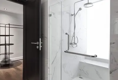 a bathroom with a shower with a glass door at S Ram Leisure Hotel in Bangkok