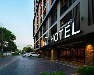 a hotel sign on the side of a building at The Home Hotel SHA in Bangkok