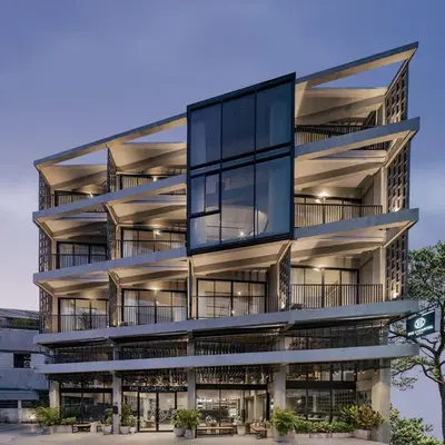 an exterior view of a building with balconies at Palette The Ex Capital Hotel Bangkok in Bangkok