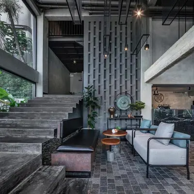 a living room with a couch and a table at Palette The Ex Capital Hotel Bangkok in Bangkok