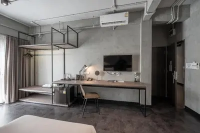 an office with a desk and a chair in a room at Palette The Ex Capital Hotel Bangkok in Bangkok