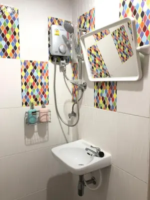 a bathroom with a sink and a mirror at Great House 99 in Bangkok