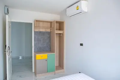 a room with a kitchen with a cupboard at Rich8 Hostel in Bangkok