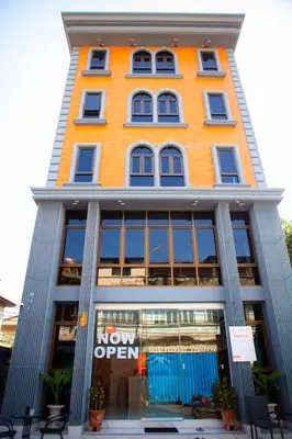 a orange building with a now open sign on it at Rich8 Hostel in Bangkok