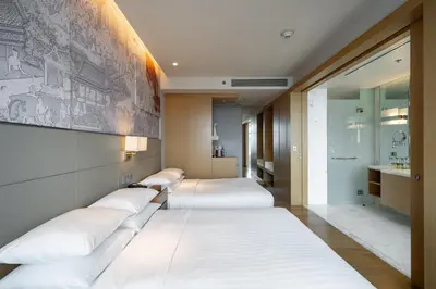 a row of beds in a hotel room at Bangkok Marriott Hotel Sukhumvit in Bangkok
