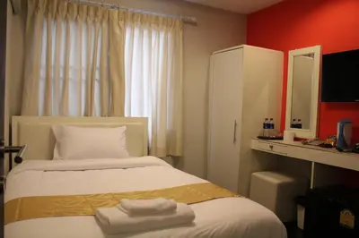 a hotel room with a bed with towels on it at V30 Sukhumvit in Bangkok