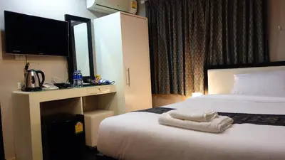 a hotel room with a bed with towels on it at V30 Sukhumvit in Bangkok