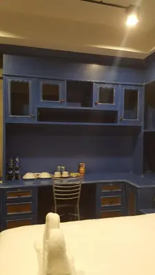 a blue kitchen with a table and a chair at bangkok bed place in Bangkok