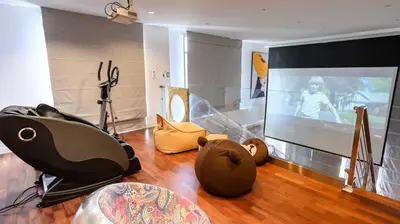 a living room with a flat screen tv and toys at Benviar Tonson Residence in Bangkok