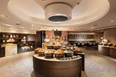 a restaurant with a buffet of food on display at Conrad Bangkok Residences in Bangkok