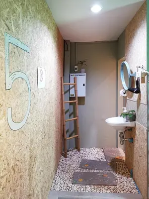 a bathroom with a staircase and a sink at FORESTTEL.BKK in Bangkok