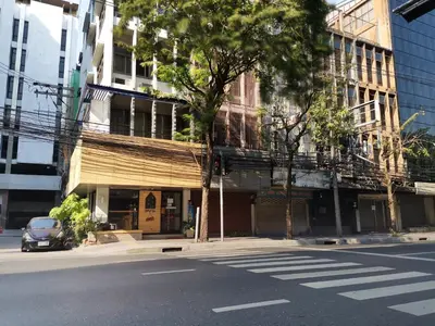 an empty street in a city with a building at FORESTTEL.BKK in Bangkok