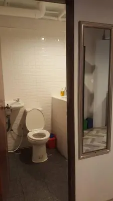 a bathroom with a toilet and a sink at JS mansion in Bangkok