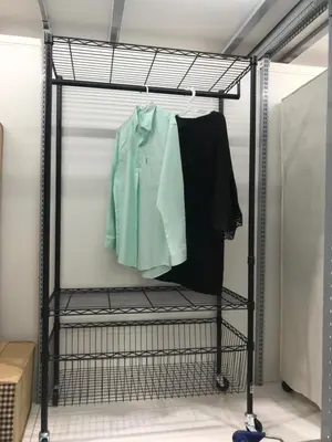 a black rack with a green shirt on it at JS mansion in Bangkok