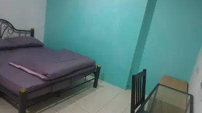 a bedroom with a bed and a glass table at JS mansion in Bangkok