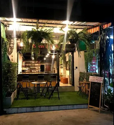 a restaurant with a table and chairs in front of it at JS mansion in Bangkok