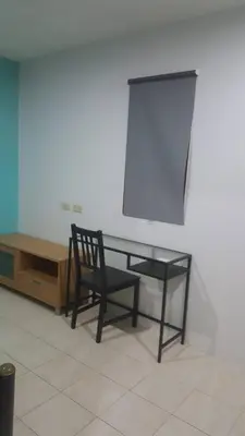 a black chair sitting next to a glass table at JS mansion in Bangkok