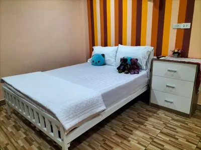 a bed with two stuffed animals sitting on it at พีเพลส in Bangkok