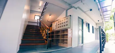 a staircase in a building with a sign for a library at Bed garden 26 in Bangkok