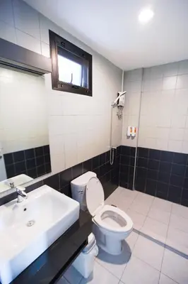a bathroom with a toilet and a sink at Bed garden 26 in Bangkok