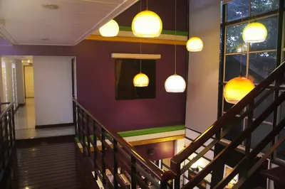 a staircase in a restaurant with lights on the wall at Erawan House in Bangkok