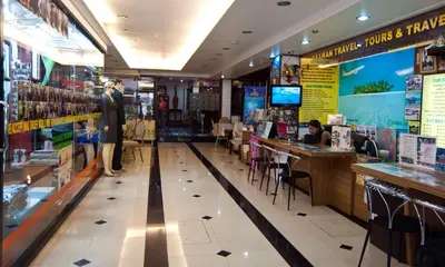 a restaurant with people sitting at tables in a store at Erawan House in Bangkok