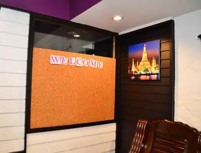 a room with a welcome sign and a tv on the wall at Erawan House in Bangkok