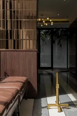 a room with a bench and a table in it at Hotel Amber Sukhumvit 85 in Bangkok