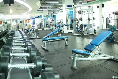 a gym with rows of dumbbells and other equipment at Park Village Rama II in Bangkok