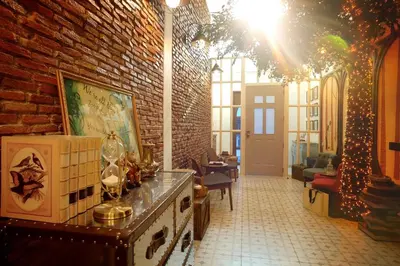 a living room with a brick wall and a christmas tree at Hide and Seek Boutique Hometel in Bangkok