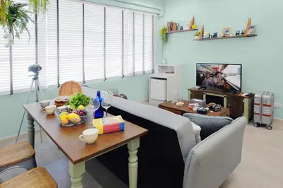 a living room with a table and a couch at Hide and Seek Boutique Hometel in Bangkok