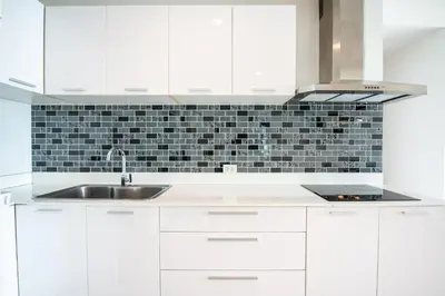 a kitchen with white cabinets and a sink at Prime 11, High Floor Over Pool, 2 Br, 2 Balcony in Bangkok