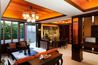 a living room with a couch and a table at Baan Wanglang Riverside, Bangkok in Bangkok