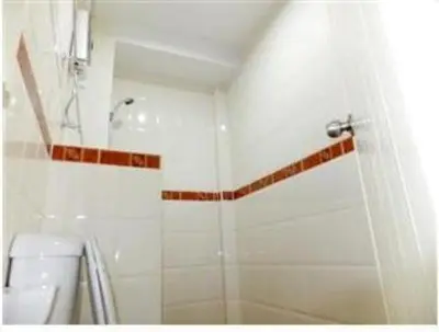 a bathroom with a shower and a sink at Orchid Inn in Bangkok