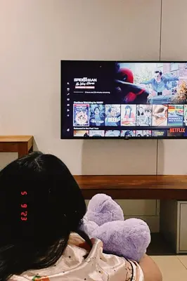 a person laying on the floor in front of a tv at SUNKISS in Bangkok Noi