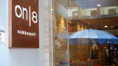 a sign in the window of a store with an umbrella at On 8 Sukhumvit Nana Bangkok in Bangkok