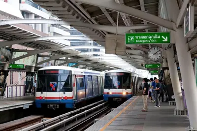 two trains in a subway station with people on the platform at On 8 Sukhumvit Nana Bangkok in Bangkok