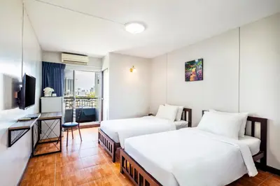 a hotel room with two beds and a television at Livotel Express Hotel Bang Kruai Nonthaburi - No Parking in Nonthaburi