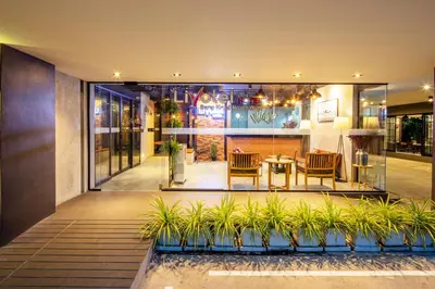 a house with a courtyard with a table and chairs at Livotel Express Hotel Bang Kruai Nonthaburi - No Parking in Nonthaburi