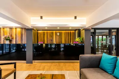 a living room with a couch and a table at Livotel Express Hotel Ramkhamhaeng 50 Bangkok - No Parking in Bangkok