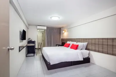 a hotel room with a bed with red pillows at Livotel Express Hotel Ramkhamhaeng 50 Bangkok - No Parking in Bangkok