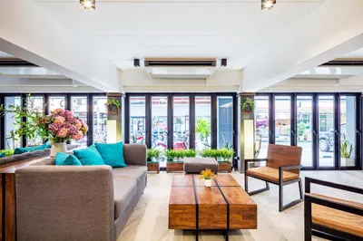 a living room with a couch and a table at Livotel Express Hotel Ramkhamhaeng 50 Bangkok - No Parking in Bangkok