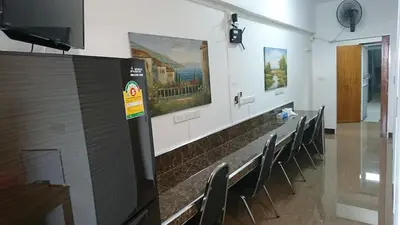 a room with chairs and paintings on the wall at 18floor condo close to MRTwith 2 bedrooms in Hua mak in Bangkok