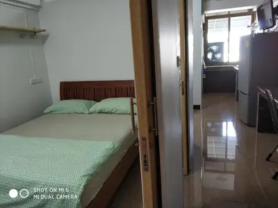 a bedroom with a bed and a door to a room at 18floor condo close to MRTwith 2 bedrooms in Hua mak in Bangkok