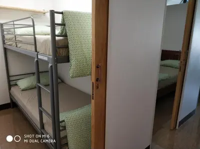 a room with two bunk beds and a door at 18floor condo close to MRTwith 2 bedrooms in Hua mak in Bangkok