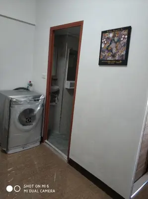 a bathroom with a washing machine and a picture on the wall at 18floor condo close to MRTwith 2 bedrooms in Hua mak in Bangkok