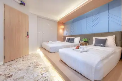 two beds in a hotel room with two bedsvisor at Tori Prestige Bangkok Hotel in Bangkok