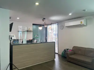 a living room with a couch and a counter at 24Residence Siriraj in Bangkok
