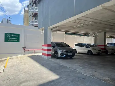 two cars are parked in a parking lot at 24Residence Siriraj in Bangkok