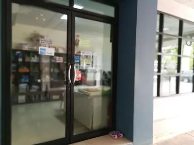 a glass door of a store with at Komol Residence Bangkok in Bangkok